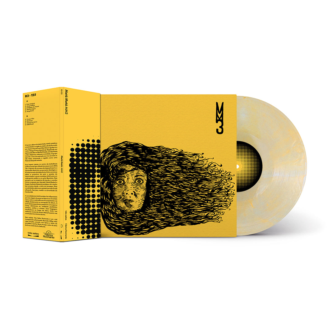 Conjunto da edição em disco de vinil do álbum "MM3", do Metá Metá. À esquerda, a capa com a xilogravura do rosto de cabelos ao vento exibe na lateral um OBI bege e preto com padrão de retículas e informações do lançamento. Do lado direito da capa, projeta-se um LP de vinil amarelo translúcido marmorizado com textura de nuvens em tom bege-claro e selo central preto em padrão reticulado.