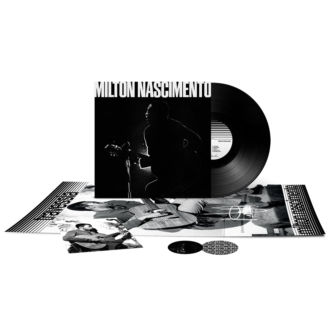Capa do álbum Travessia de Milton Nascimento com o disco de vinil parcialmente para fora, pôster e foto expostos.