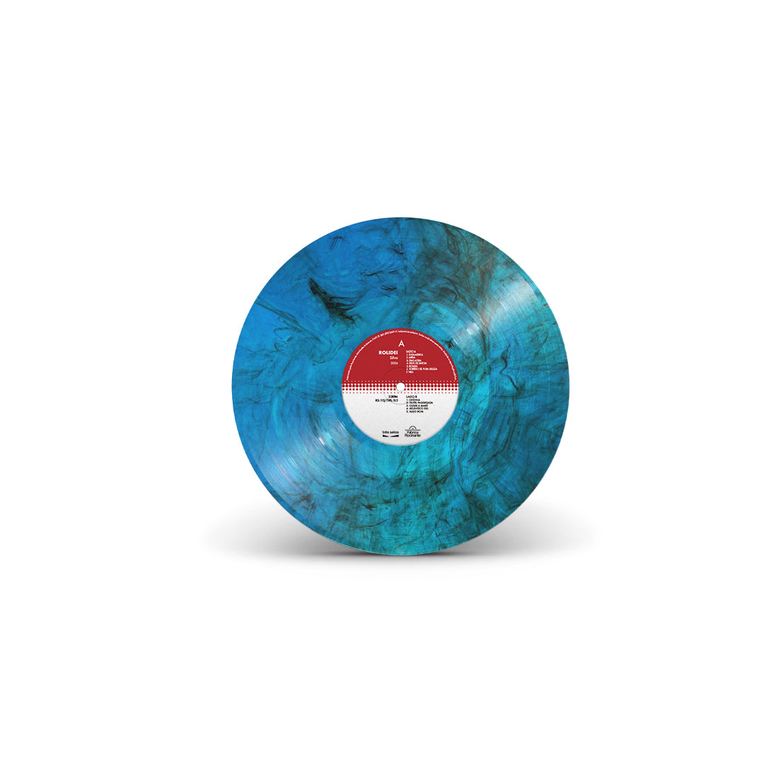 Disco de vinil azul marmorizado do álbum “Rolidei” do artista Silva, com acabamento mesclado em tons de azul e preto e rótulo central, isolado sobre fundo neutro (disco de vinil).